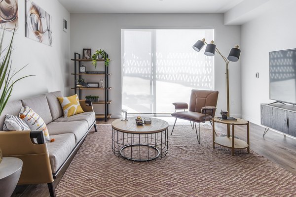 Chic living room with natural light and modern furniture in The Union Apartments, a luxury Greystar community