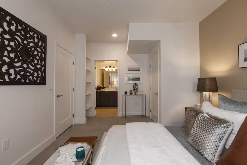 Bedroom featuring modern decor and plush bedding at Encasa Apartments