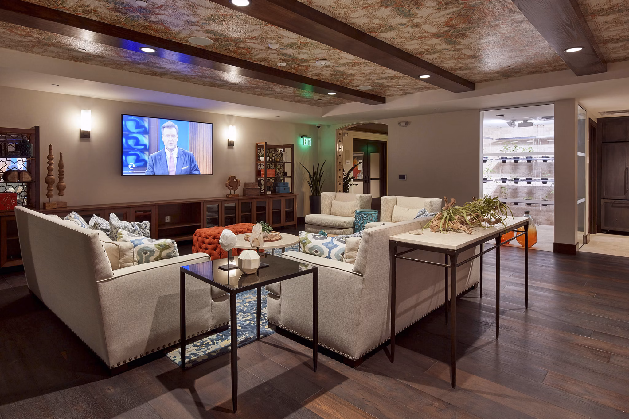 Modern living room with a large sectional sofa and decorative plants in luxury apartment