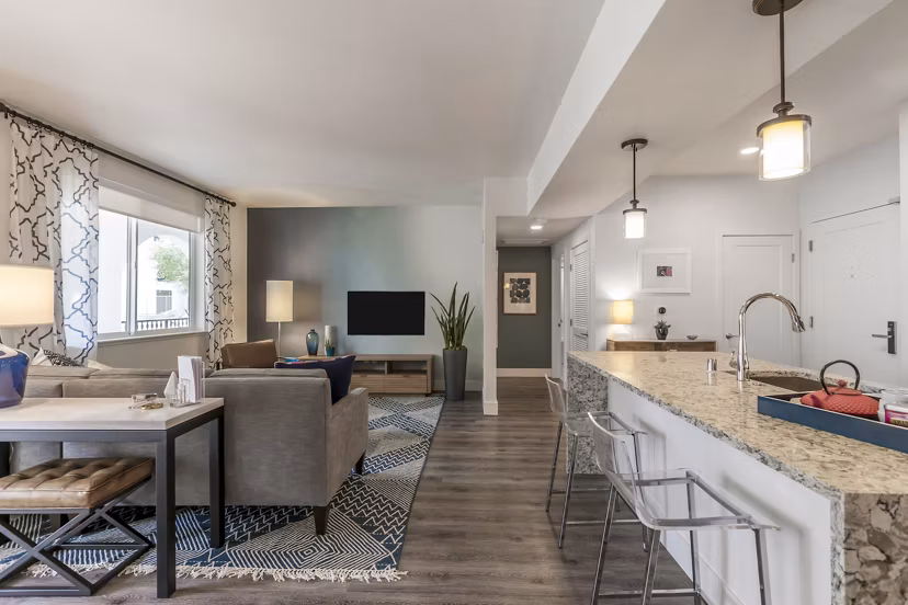 Spacious living room with modern decor in Encasa Apartments, luxury Greystar property