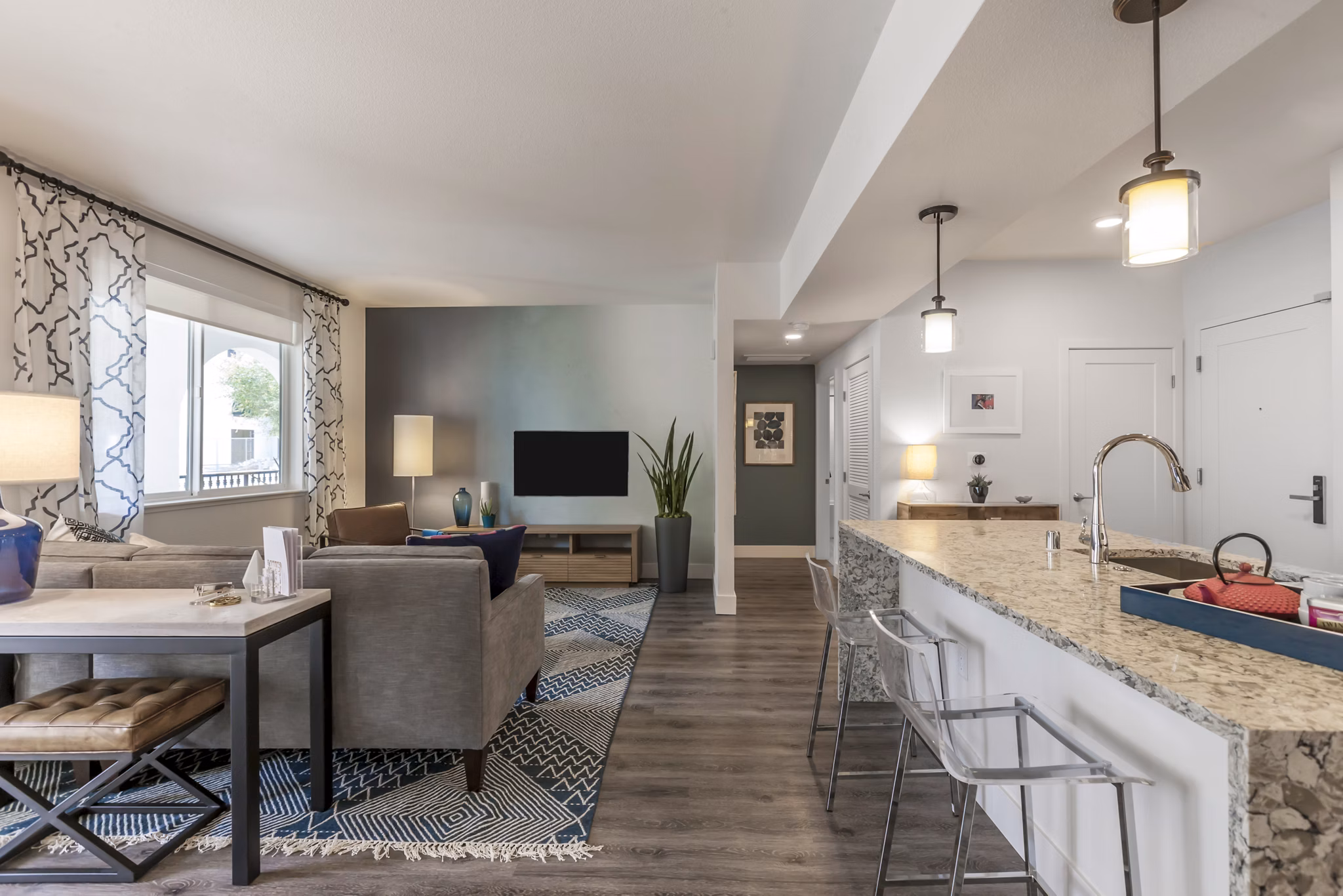 Spacious living room with modern decor in Encasa Apartments, luxury Greystar property