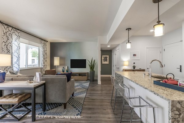 Spacious living room with modern decor in Encasa Apartments, luxury Greystar property