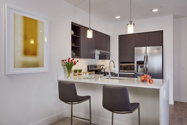 Kitchen with granite countertops and stainless steel appliances in Alliance Residential apartments
