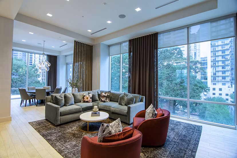 Modern clubhouse featuring a spacious lounge and bar area at Piedmont House Apartments