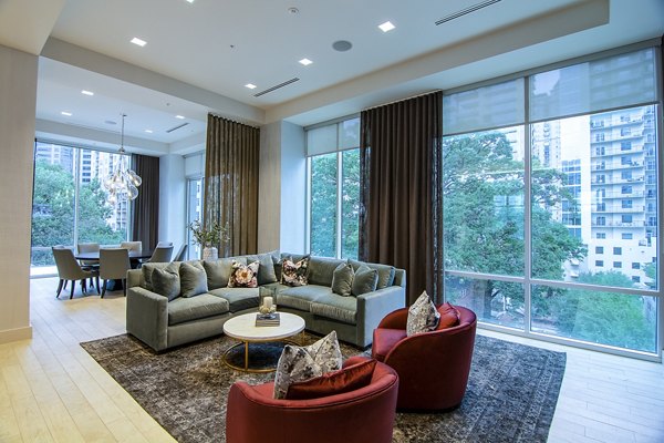Modern clubhouse featuring a spacious lounge and bar area at Piedmont House Apartments
