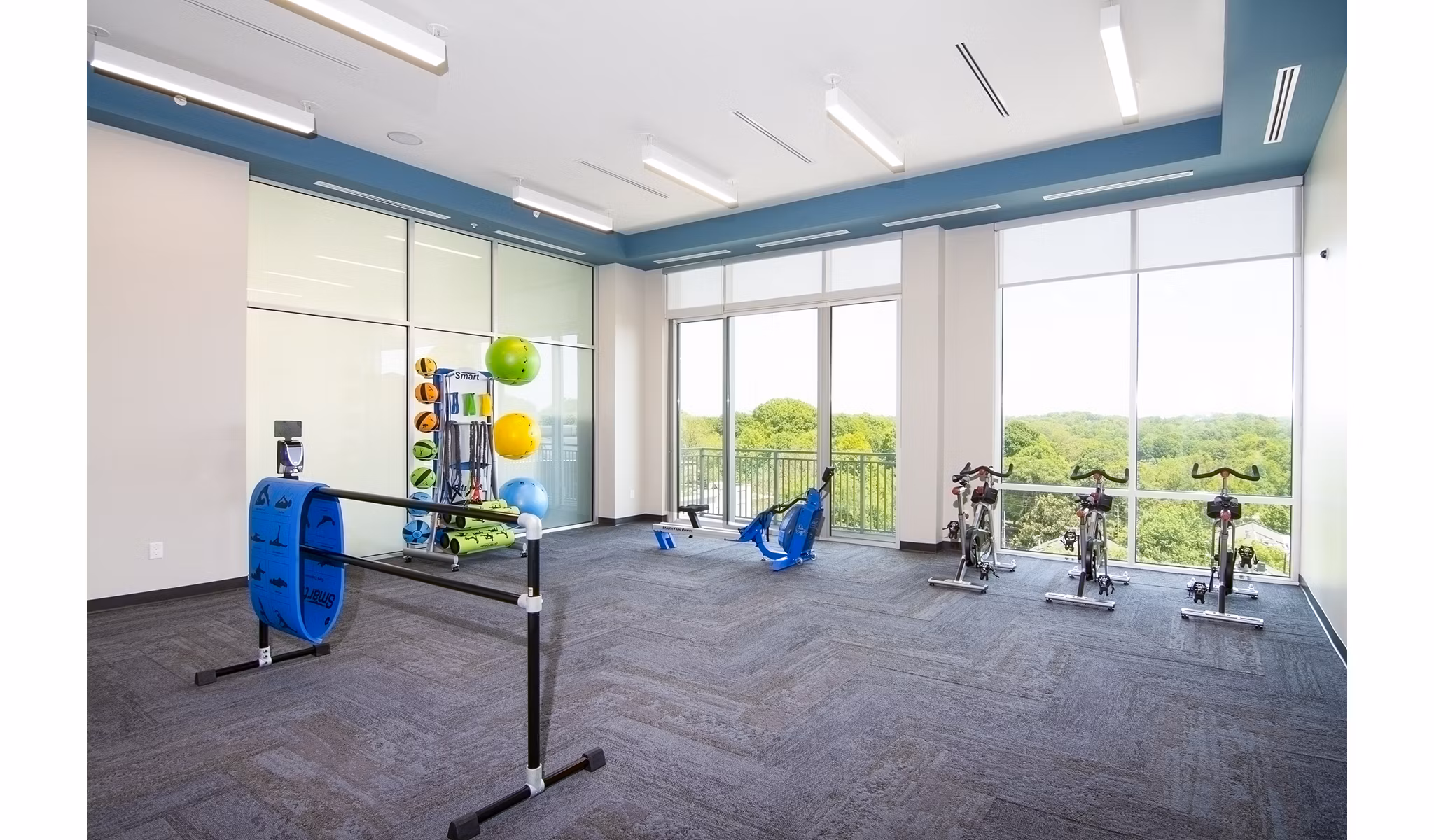 Yoga and spin studio equipped with modern bikes and mats at Piedmont House Apartments