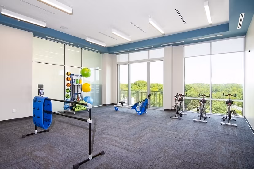 Yoga and spin studio equipped with modern bikes and mats at Piedmont House Apartments