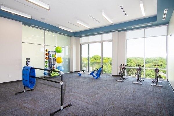 Yoga and spin studio equipped with modern bikes and mats at Piedmont House Apartments