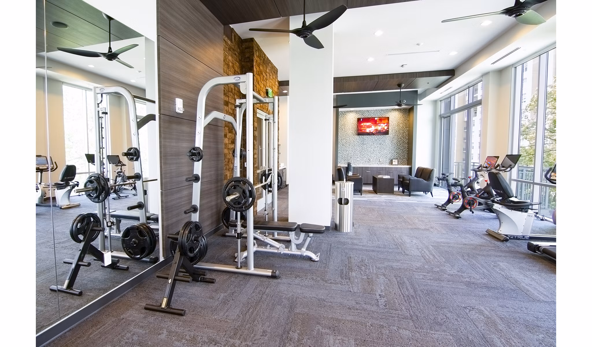 Modern fitness center with state-of-the-art equipment at Piedmont House Apartments, enhancing active living in a luxury setting
