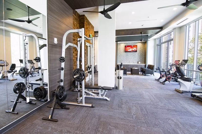 Modern fitness center with state-of-the-art equipment at Piedmont House Apartments, enhancing active living in a luxury setting
