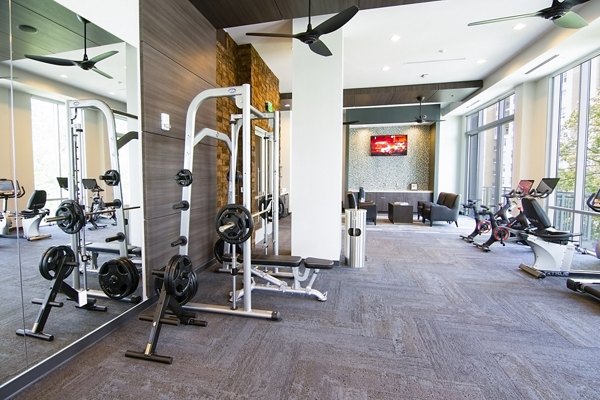 Modern fitness center with state-of-the-art equipment at Piedmont House Apartments, enhancing active living in a luxury setting