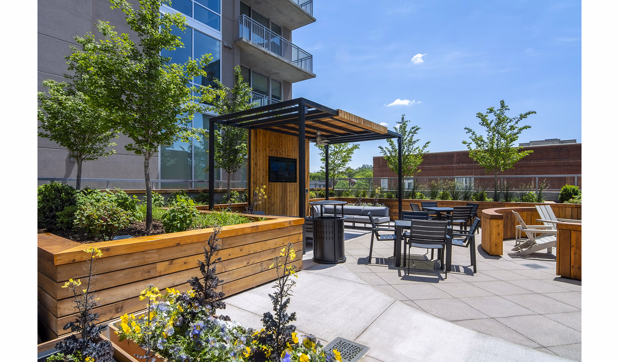 Cozy patio with seating area and skyline view at Piedmont House Apartments, a Greystar luxury living community