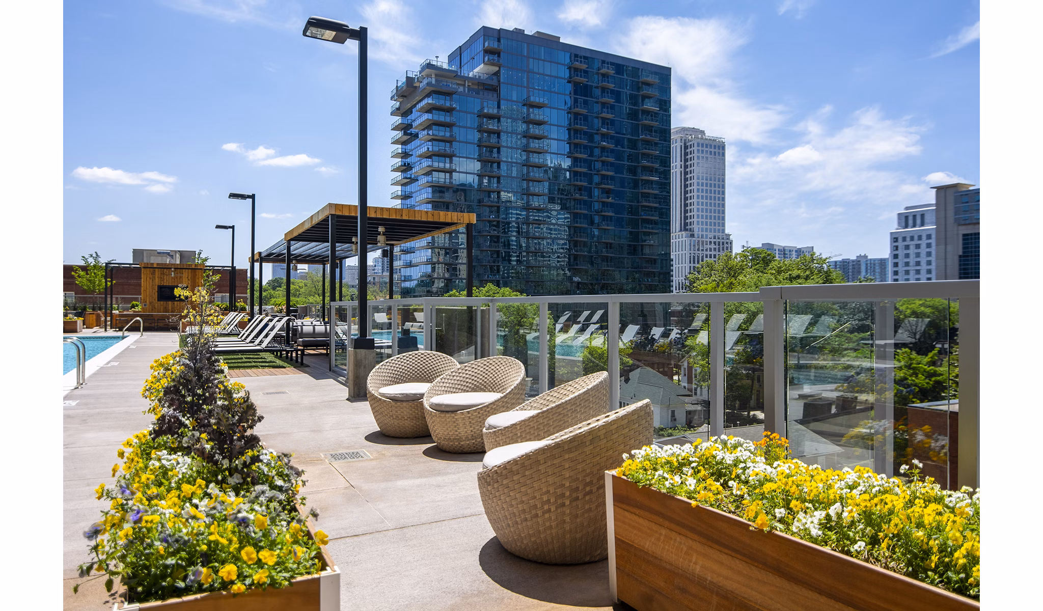 Resort-style pool at Piedmont House Apartments with lounge seating and lush landscaping