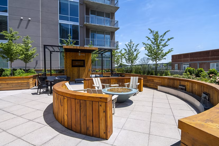 Piedmont House Apartments: Cozy patio balcony with modern seating and lush greenery, offering serene outdoor living space