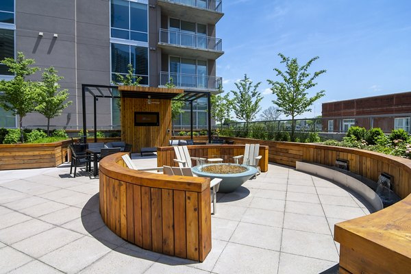 Piedmont House Apartments: Cozy patio balcony with modern seating and lush greenery, offering serene outdoor living space