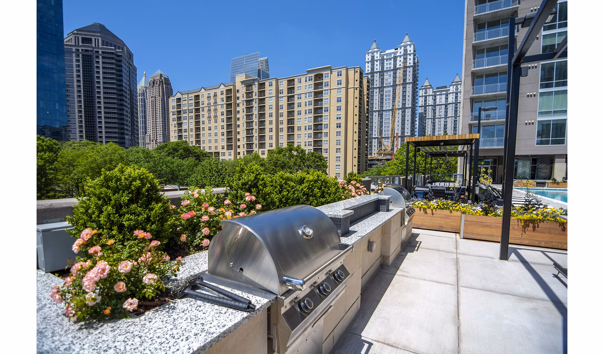 Grill area with modern seating at Piedmont House Apartments with cityscape view