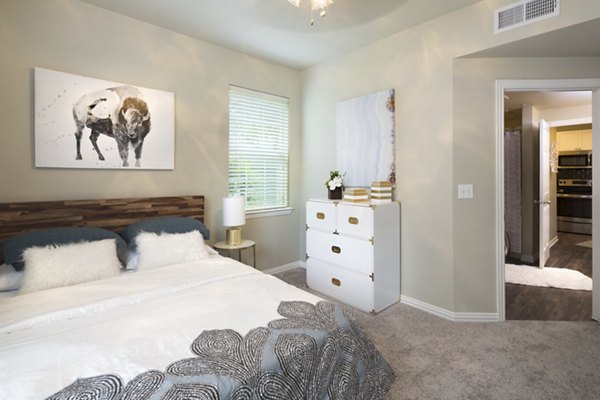 Cozy bedroom with modern decor at Grapevine TwentyFour 99 Apartments