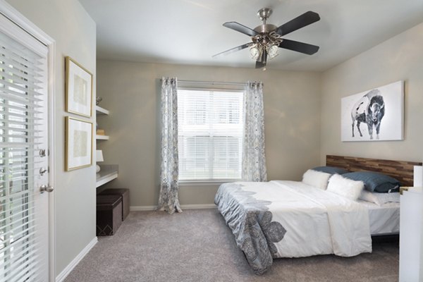 Cozy bedroom with modern decor at Grapevine TwentyFour 99 Apartments