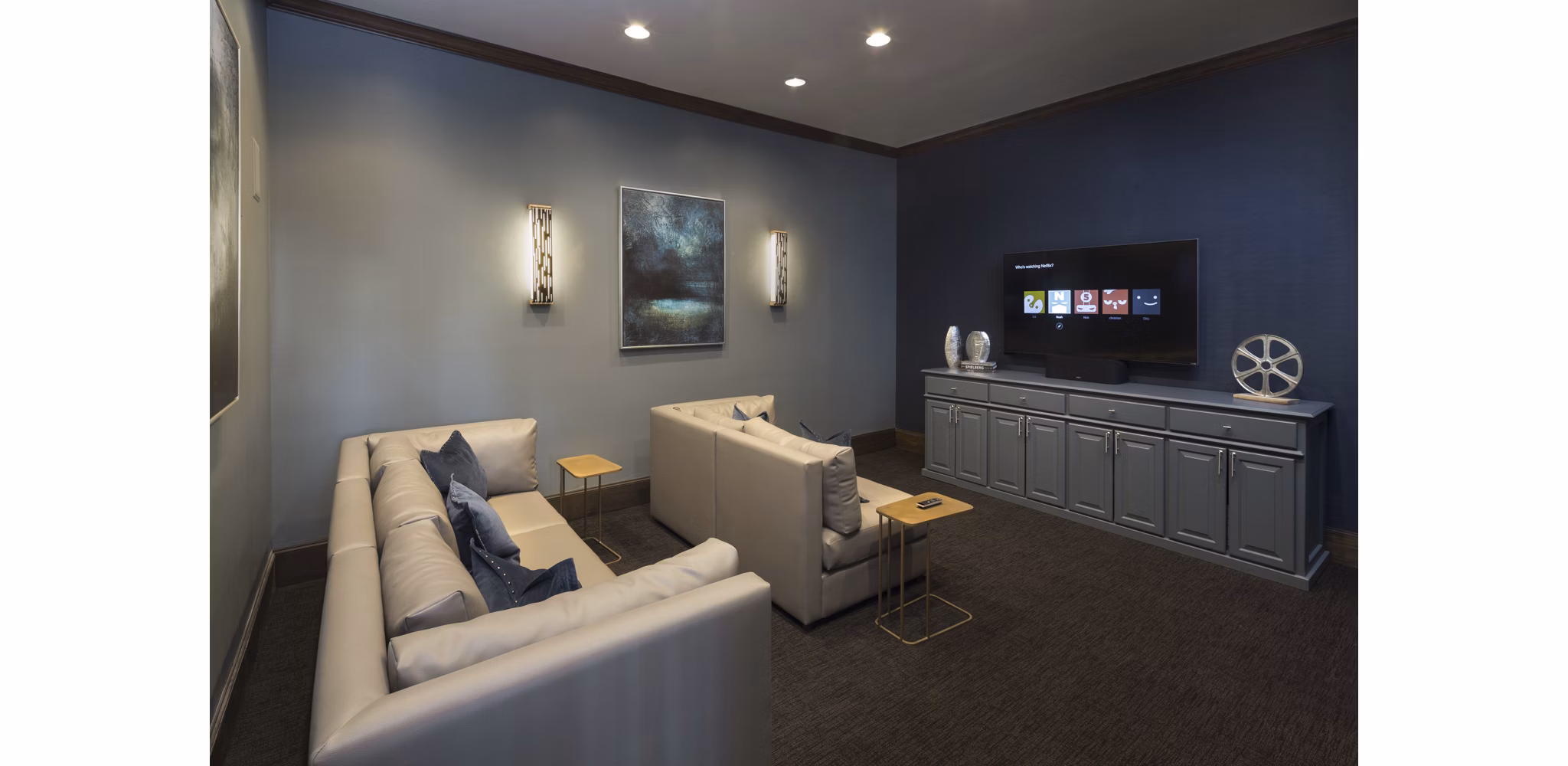 Theater room with plush seating and large screen at Grapevine TwentyFour 99 Apartments
