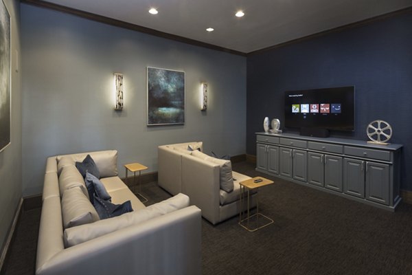 Theater room with plush seating and large screen at Grapevine TwentyFour 99 Apartments