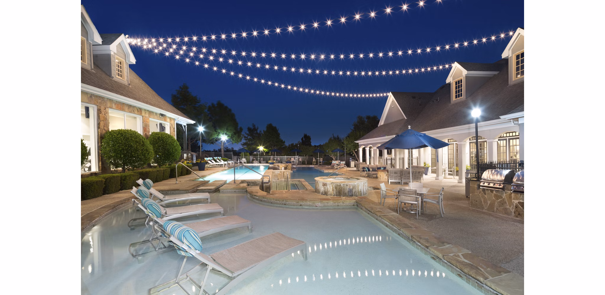 Chic pool area at Grapevine TwentyFour 99 Apartments with luxurious lounging and vibrant landscaping