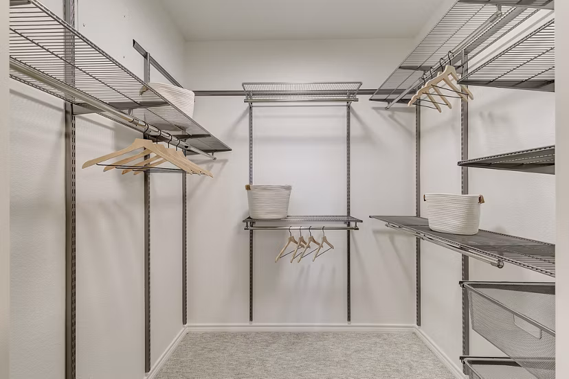 Walk-in closet with built-in shelves at Eleven11 Lexington at Flower Mound Apartments