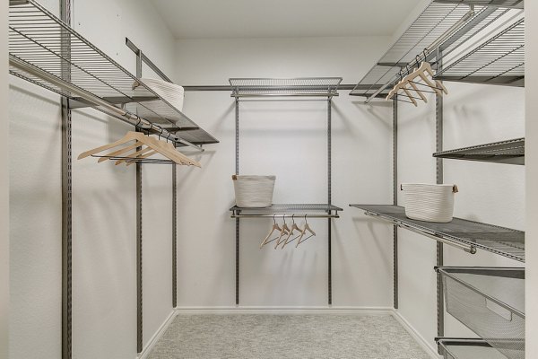 Walk-in closet with built-in shelves at Eleven11 Lexington at Flower Mound Apartments
