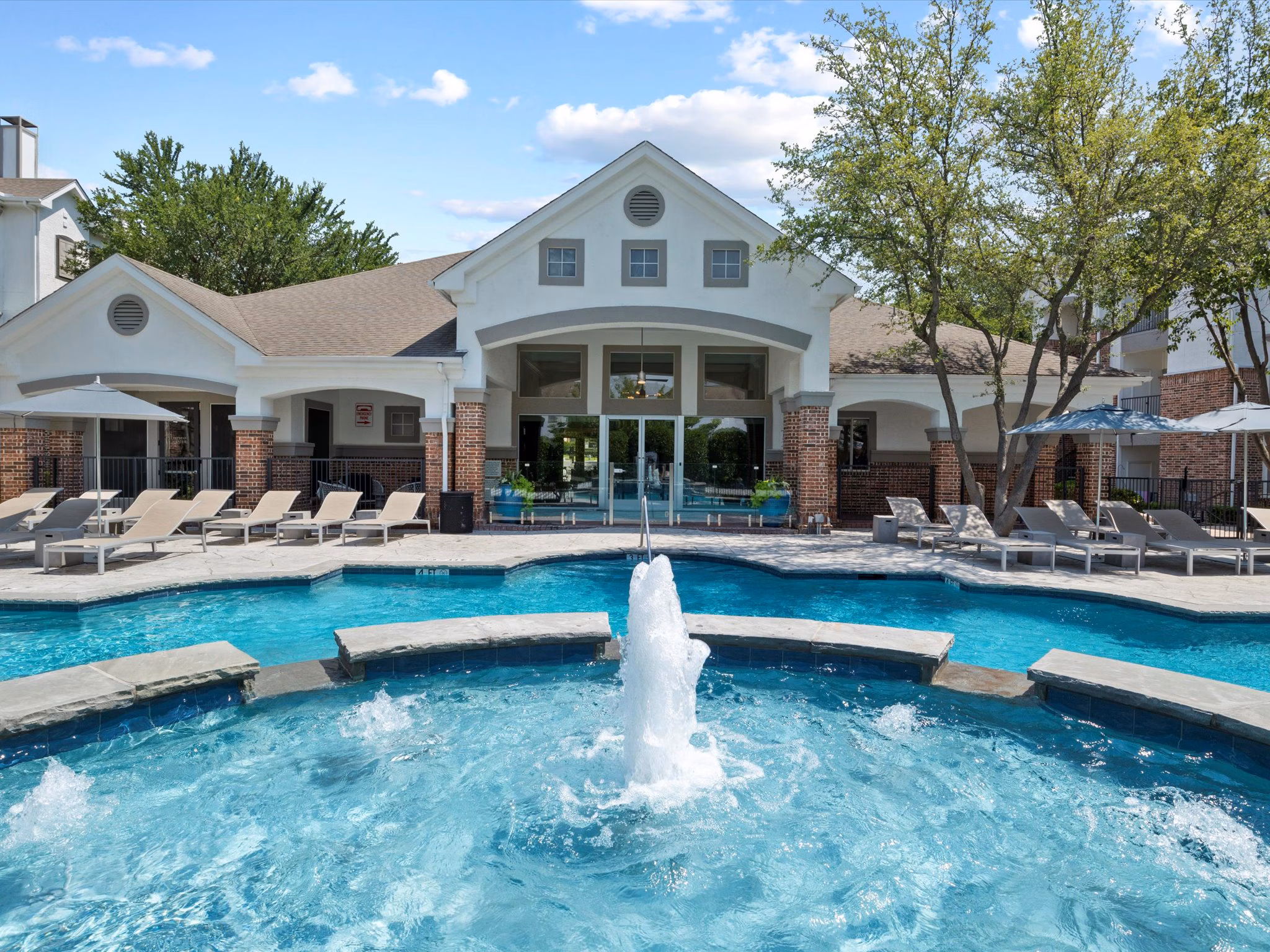 Modern pool area at Eleven11 Lexington at Flower Mound Apartments offers relaxation and leisure with luxury features in a scenic setting