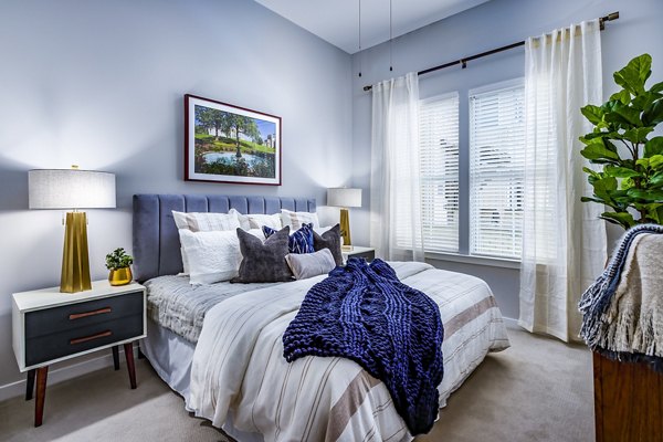 Cozy bedroom with modern decor at Everleigh Short Pump Apartments, luxury living in a vibrant community