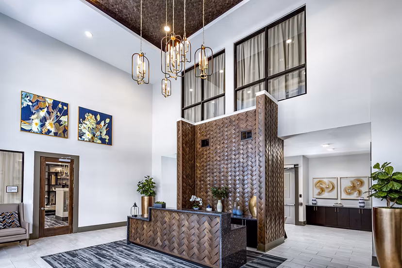 Clubhouse lobby with stylish seating and modern lighting at Everleigh Short Pump Apartments