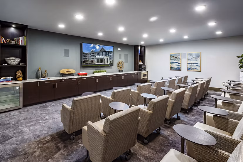 Theater room with plush seating and large screen at Everleigh Short Pump Apartments