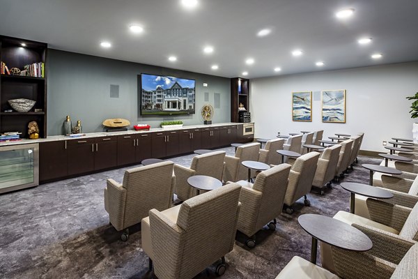 Theater room with plush seating and large screen at Everleigh Short Pump Apartments