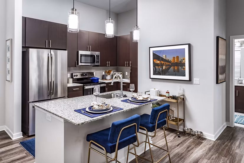 Contemporary kitchen with sleek countertops and stainless steel appliances at Everleigh Short Pump Apartments