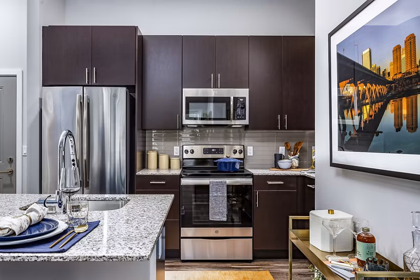 Modern kitchen featuring sleek countertops and stainless steel appliances at Everleigh Short Pump Apartments