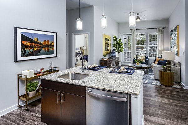 Modern kitchen with stainless steel appliances and sleek countertops in Everleigh Short Pump Apartments