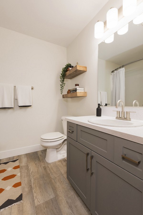 Bathroom featuring sleek fixtures and modern tiles at Cedar House Apartments