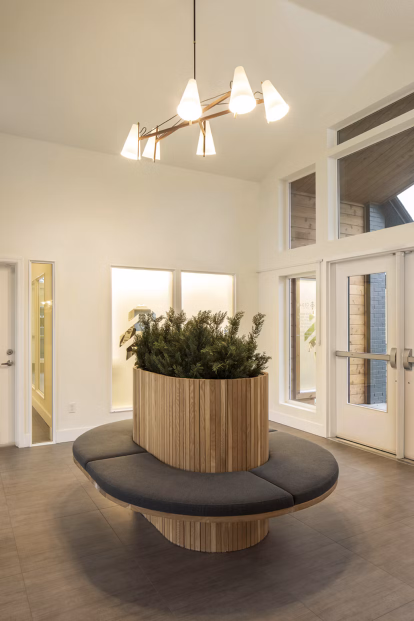 Clubhouse with modern lounge seating and large windows at Cedar House Apartments in Greystar community