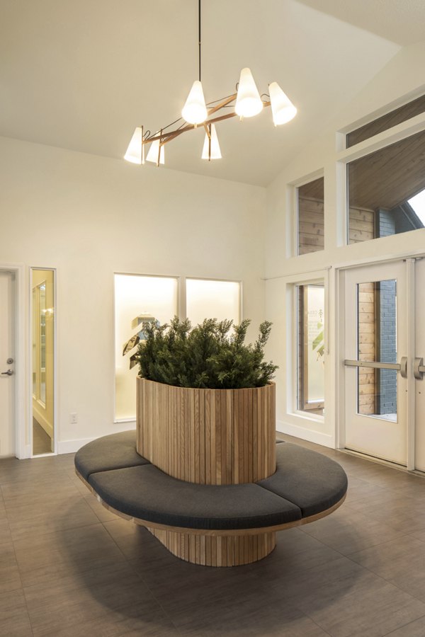 Clubhouse with modern lounge seating and large windows at Cedar House Apartments in Greystar community