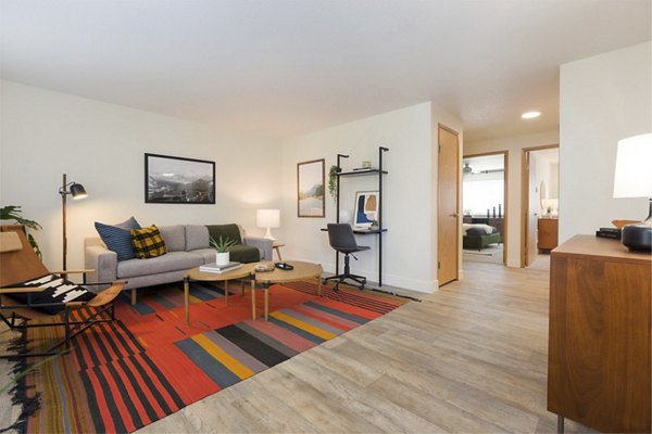 Spacious living room with modern furnishings at Cedar House Apartments