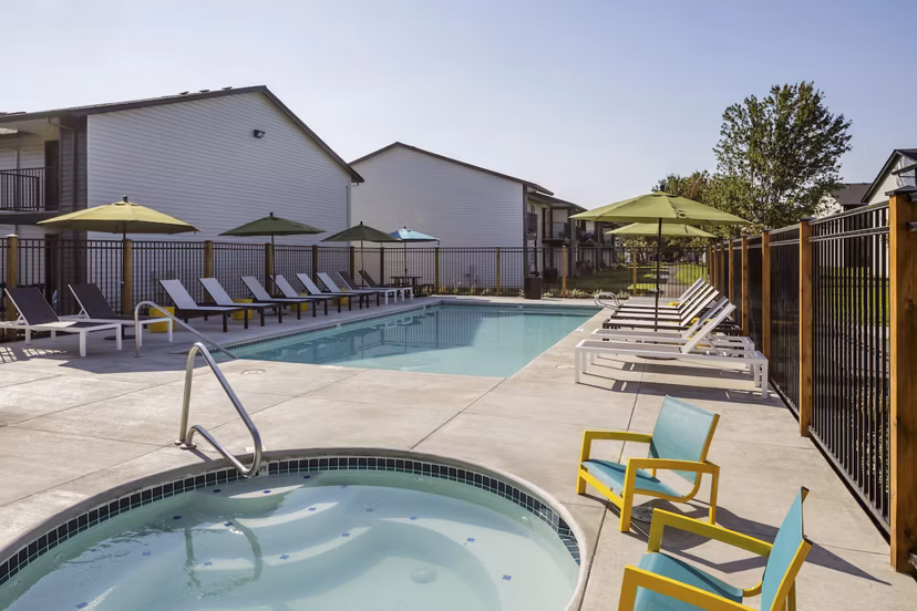 Cedar House Apartments: Sparkling outdoor pool with lounge chairs for luxury relaxation