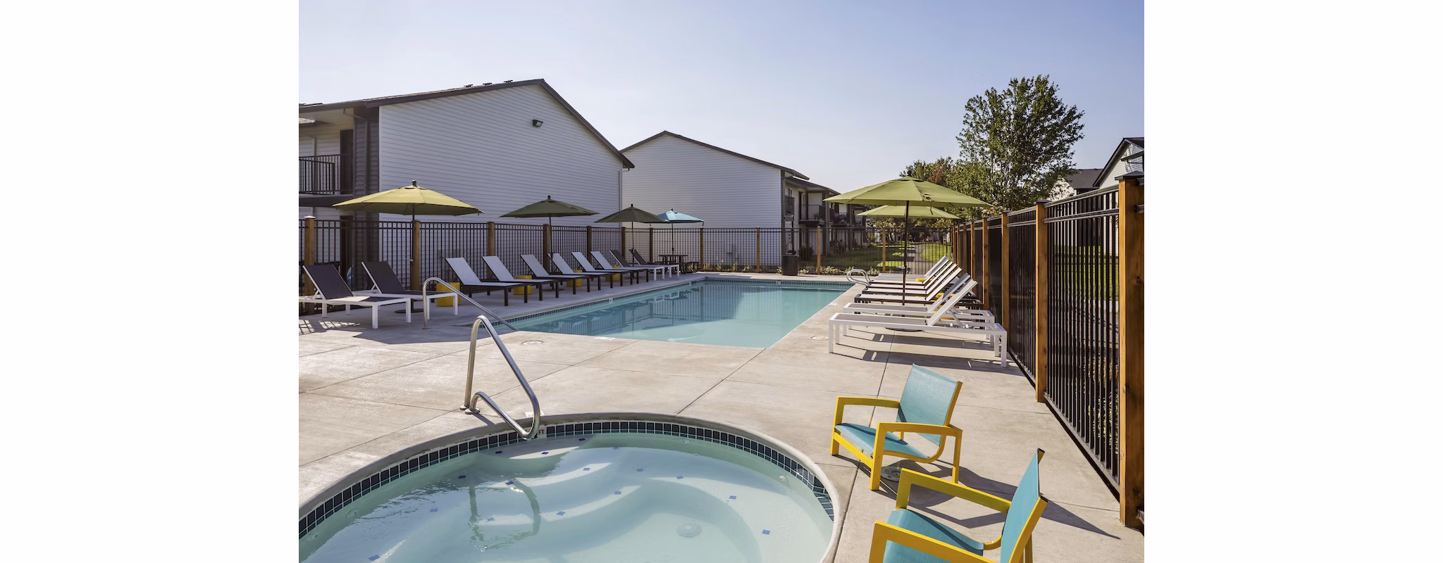 Cedar House Apartments: Sparkling outdoor pool with lounge chairs for luxury relaxation