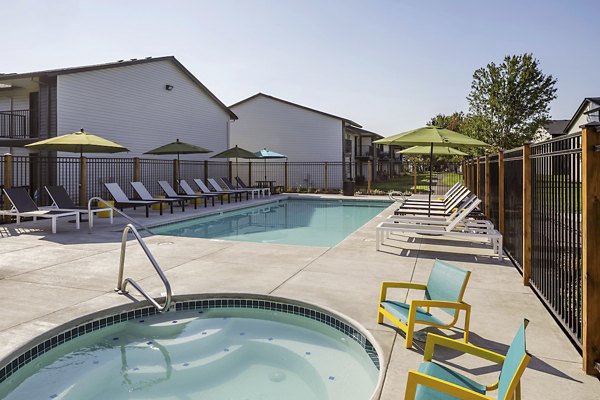 Cedar House Apartments: Sparkling outdoor pool with lounge chairs for luxury relaxation