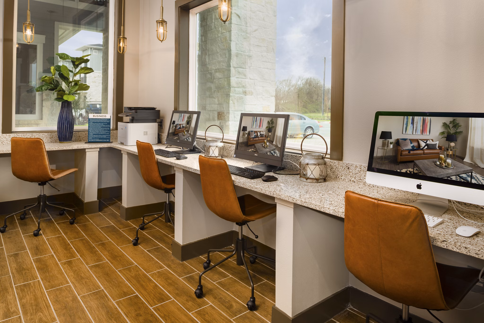Modern office space with workstations, computers, and decorative plants in luxury apartments