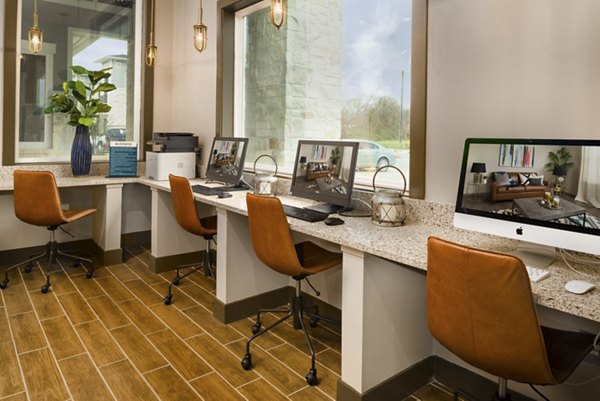 Modern office space with workstations, computers, and decorative plants in luxury apartments