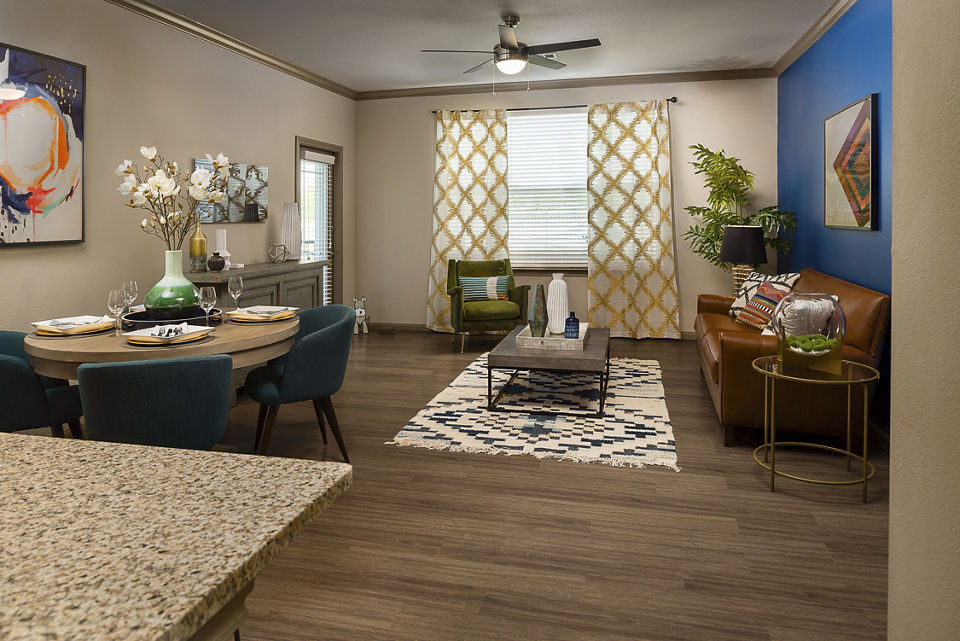 Spacious living room with modern decor and large windows at Sapphire Bay Apartments