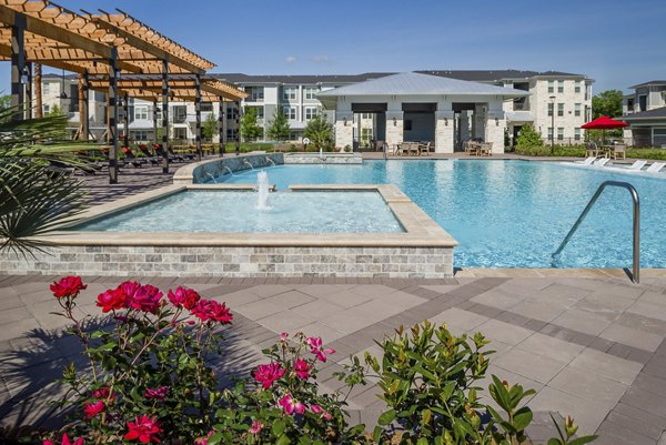 Sapphire Bay Apartments: Inviting outdoor pool area with lounge chairs and palm trees for relaxation