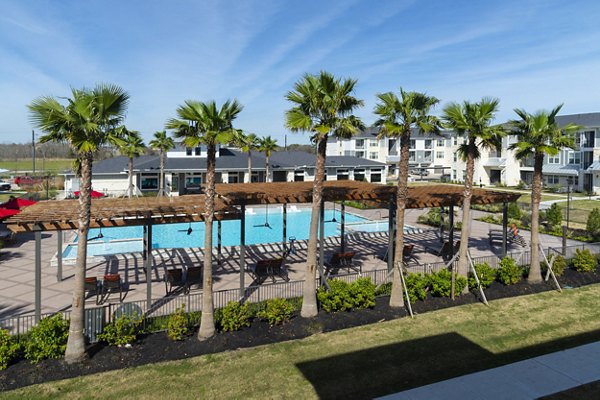 Infinity-edge pool at Sapphire Bay Apartments with palm tree surroundings, offering luxury relaxation and oceanfront views