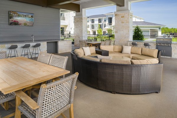 Outdoor grill area with modern seating at Sapphire Bay Apartments