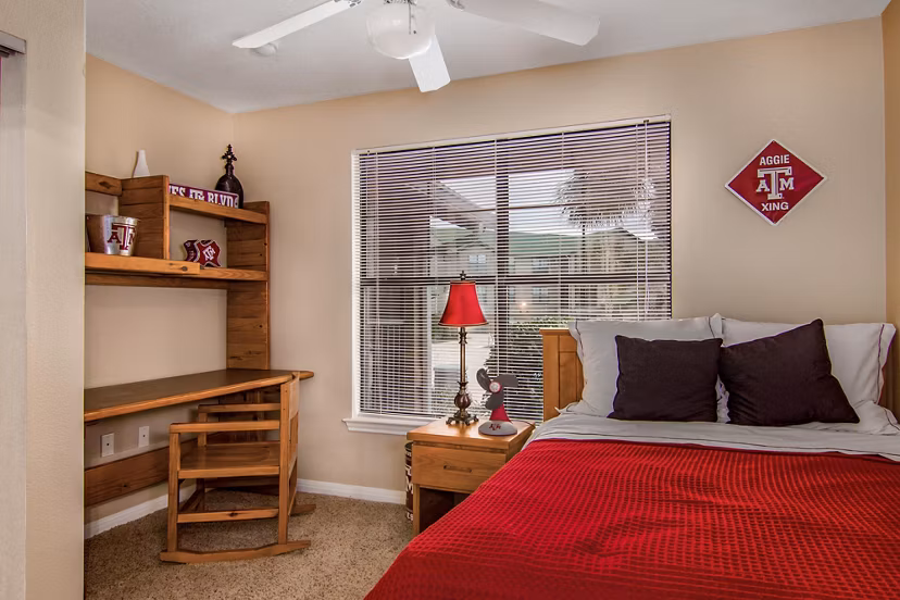 Cozy bedroom with modern furnishings at Reveille Ranch Apartments, luxury living near campus, ideal for students seeking comfort and convenience