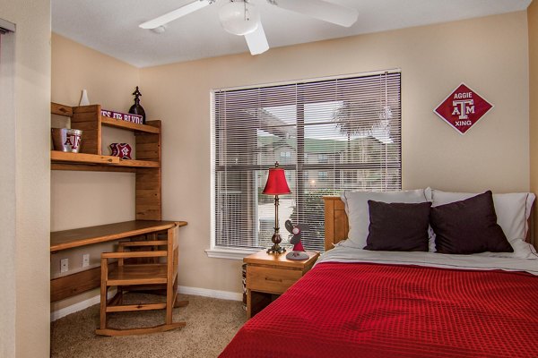 Cozy bedroom with modern furnishings at Reveille Ranch Apartments, luxury living near campus, ideal for students seeking comfort and convenience